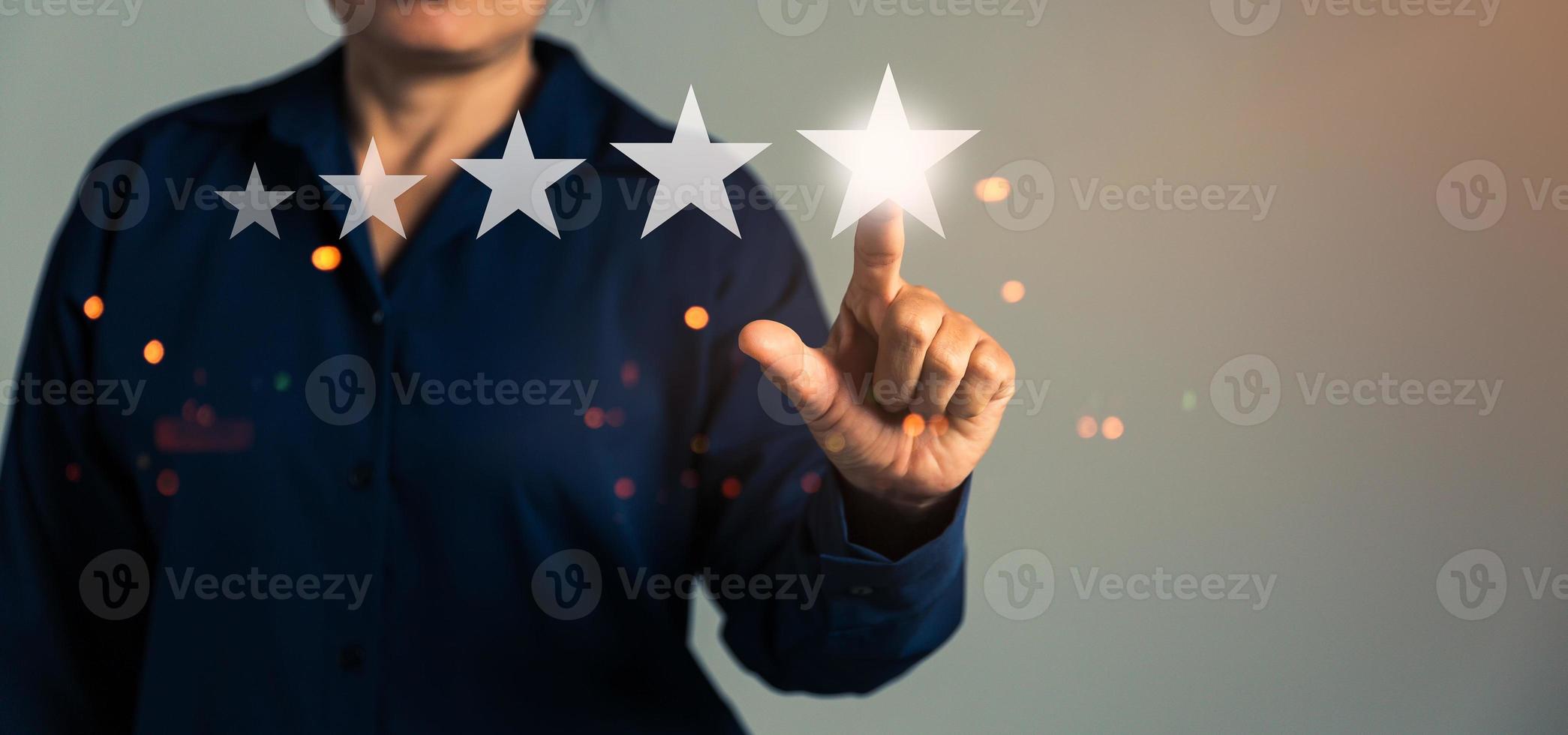Customer service feedback. Business person are touching the virtual screen on happy Smiley face icon to give satisfaction in service. Customer service and Satisfaction concept, rating very impressed. photo