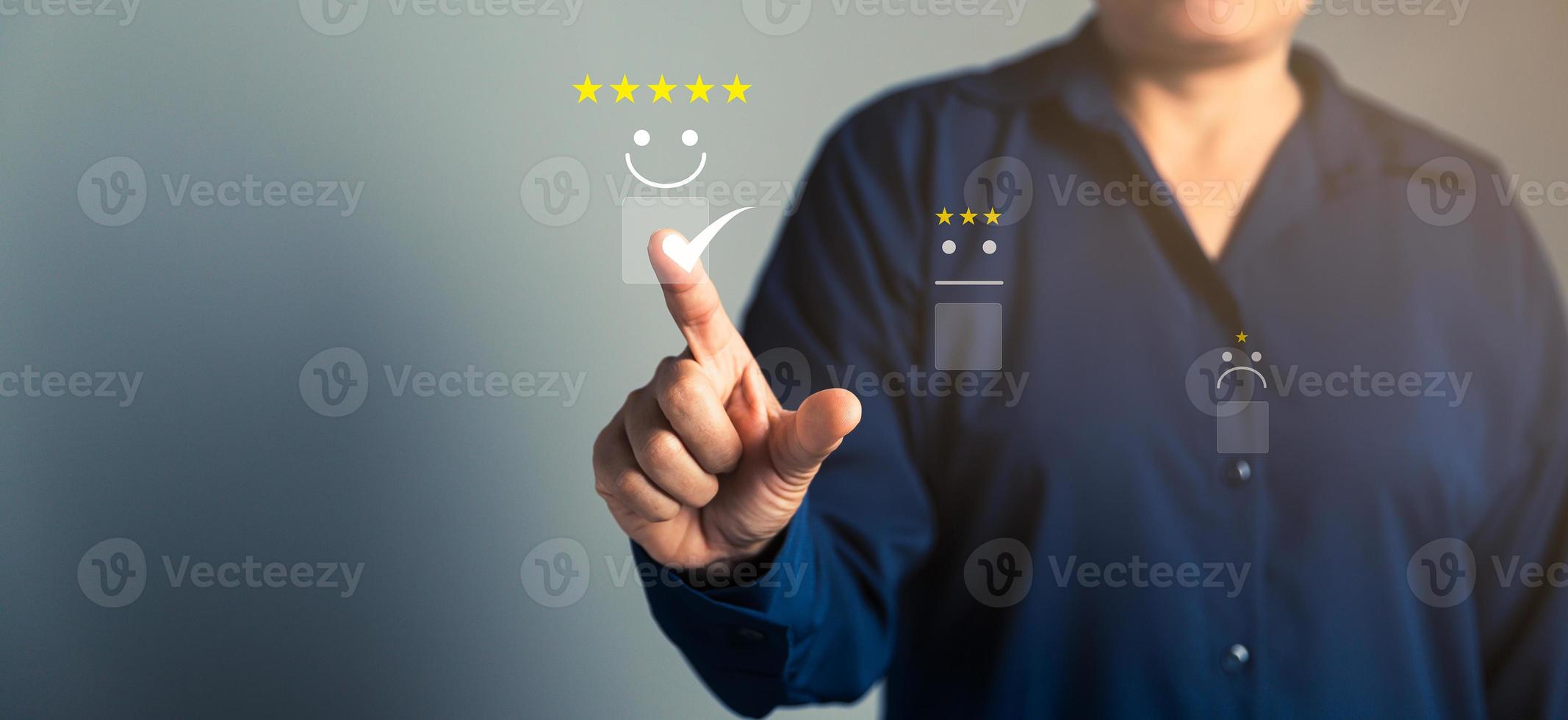 Customer service and Satisfaction concept, Business person are touching the virtual screen on happy Smiley face icon to give satisfaction in service. rating very impressed. customer service feedback. photo