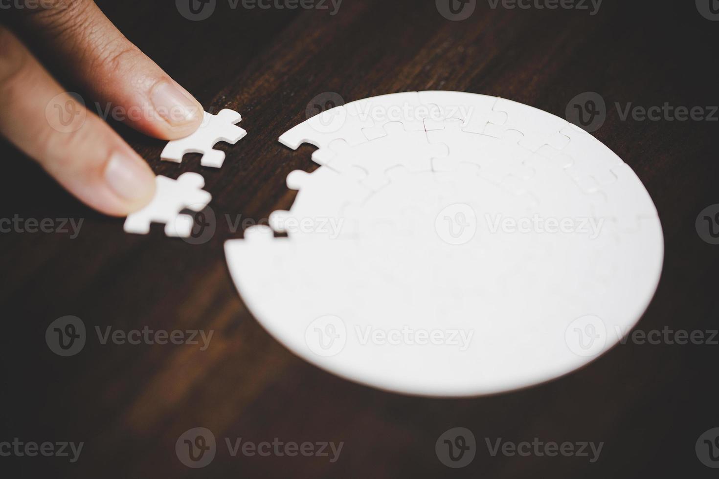 Business woman person hand with puzzle piece idea for strategy and solution. Closeup part of two white jigsaw connect together. Concept of join cooperation success teamwork-problem corporate team. photo