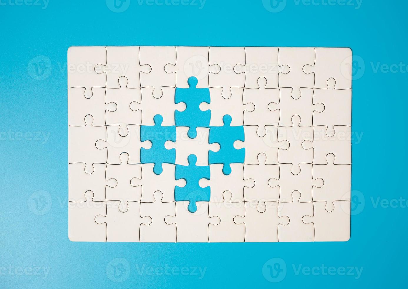 White part of jigsaw puzzle pieces on blue background. concepts of problem solving, business success, teamwork, Team playing jigsaw game incomplete, Texture photo with copy space for text