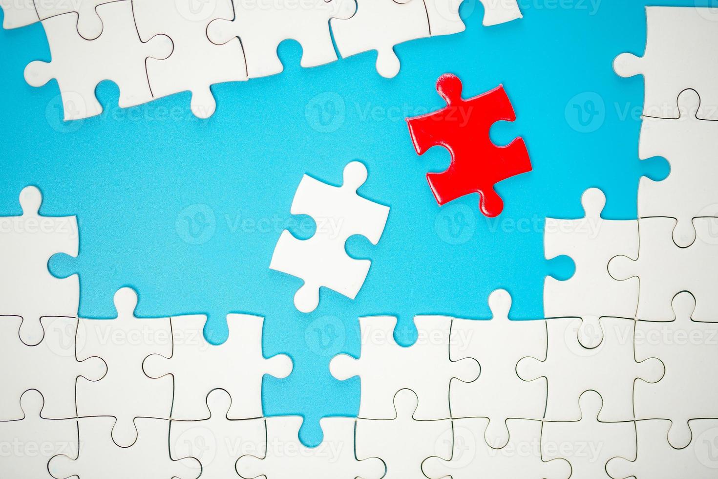 White part of jigsaw puzzle pieces on blue background. concepts of problem solving, business success, teamwork, Team playing jigsaw game incomplete, Texture photo with copy space for text