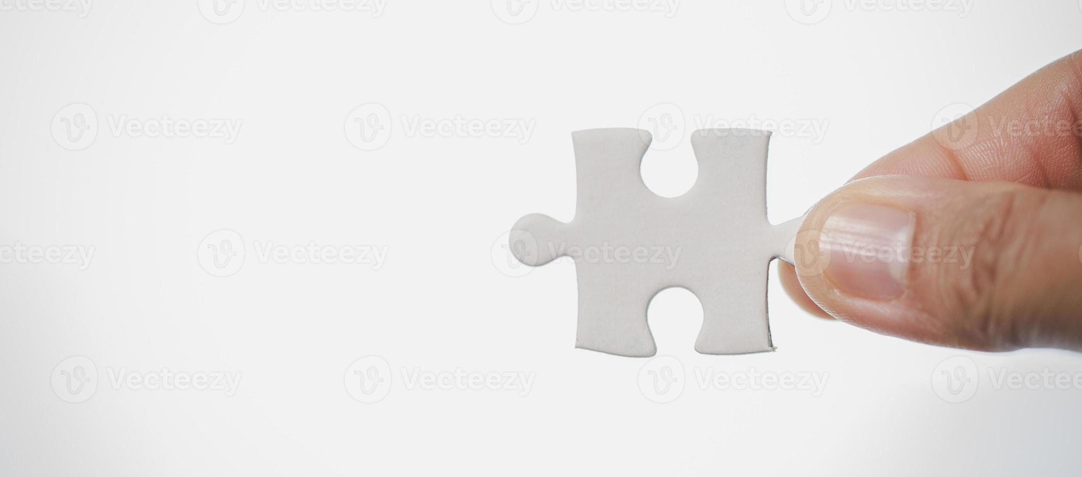 Business woman person hand holding puzzle piece idea for strategy and solution. Closeup part of two white jigsaw connect together. Concept of join cooperation success teamwork-problem corporate team photo