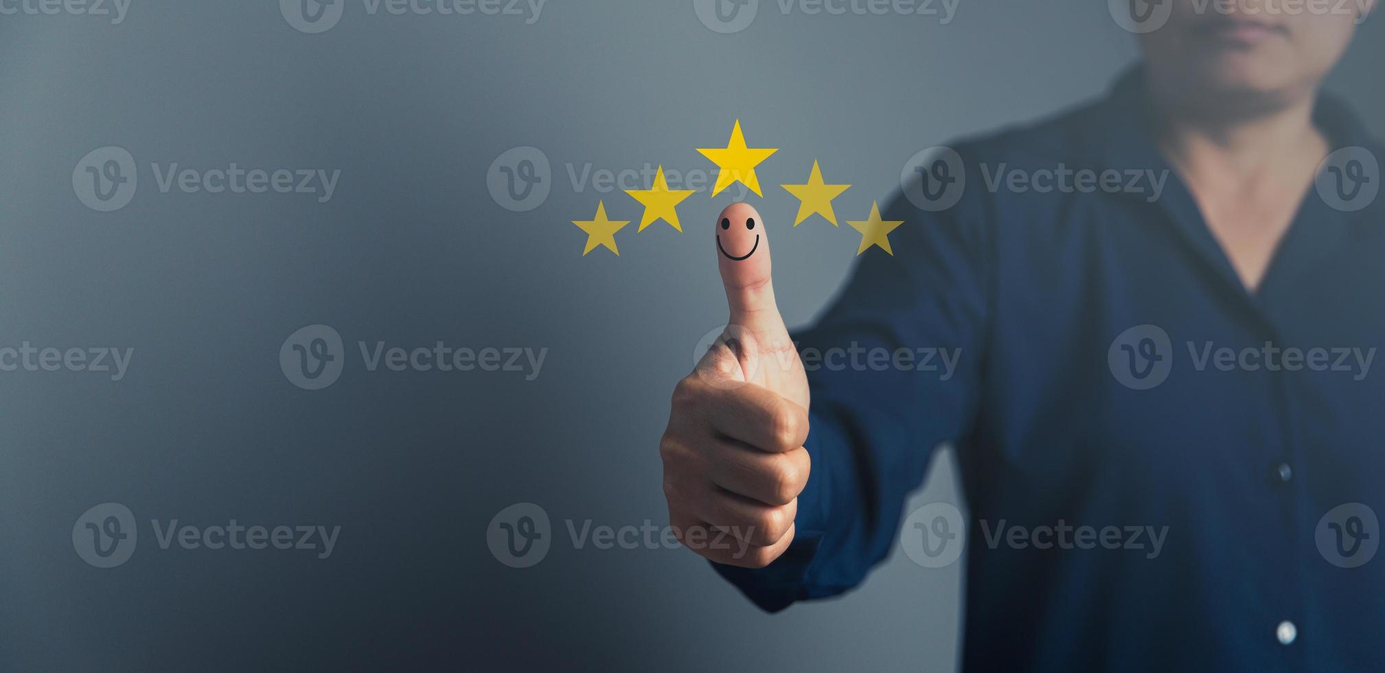 Hand with thumb up positive emotion smiley face icon and 5 star with copy space. Emotional smiley faces showing excellent satisfaction. rating very impressed. Customer service and satisfaction concept photo