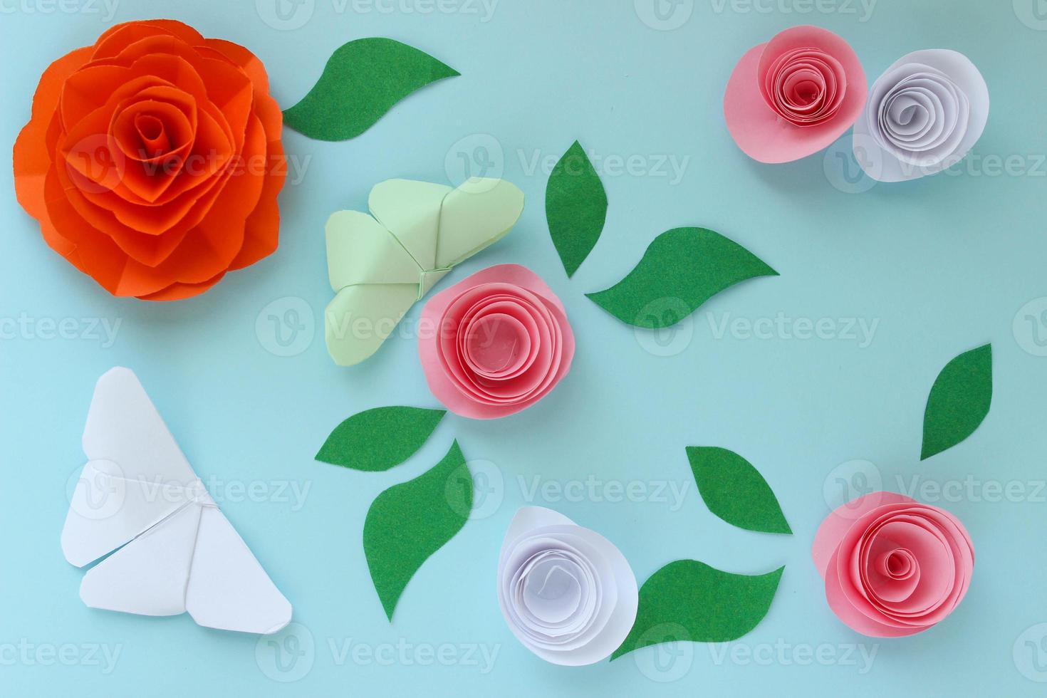 Origami paper background with butterflies, flowers and leaves. Origami composition. Paper craft photo