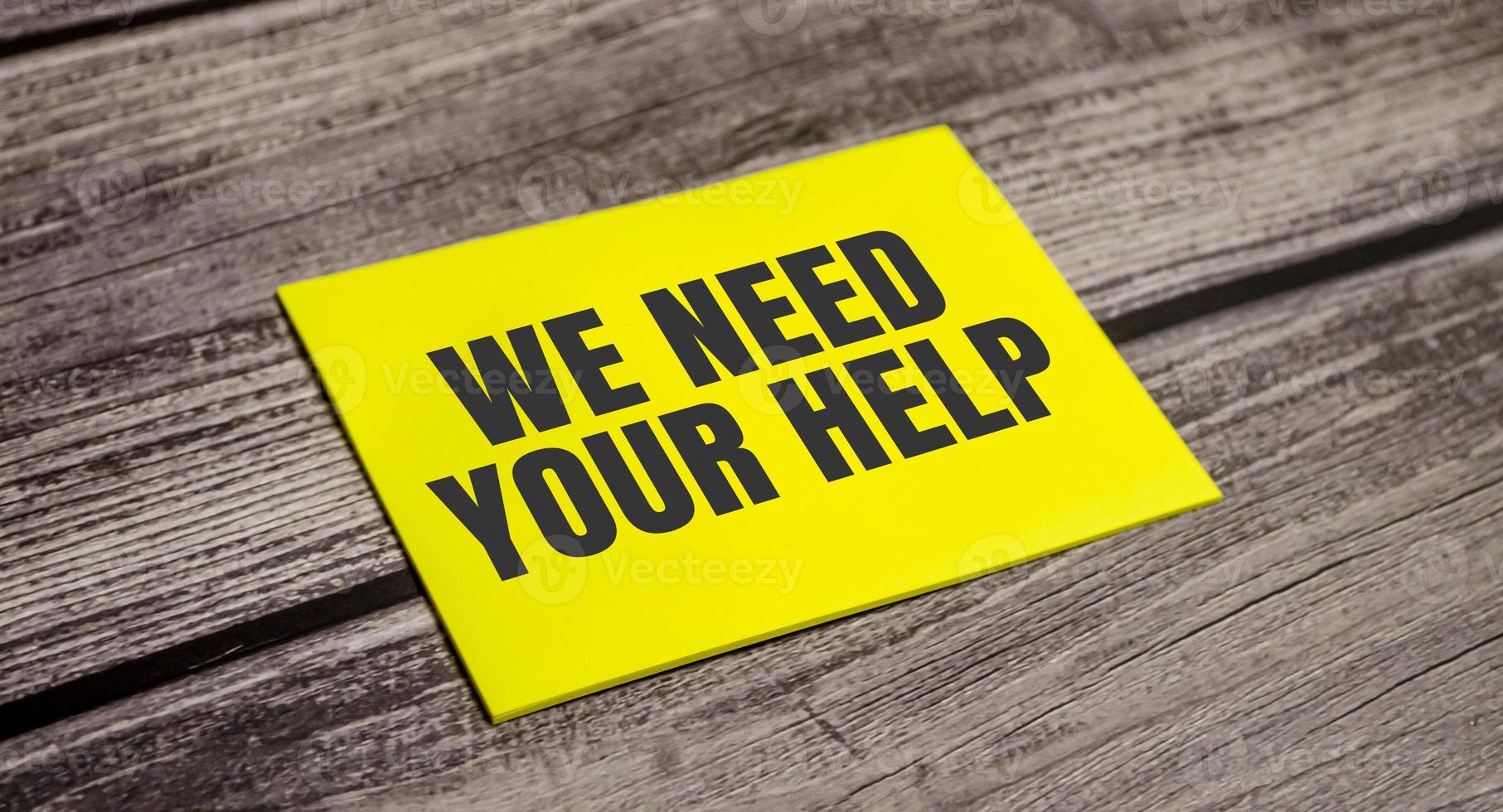 In the yellow sticker the text we NEED YOUR HELP, photo
