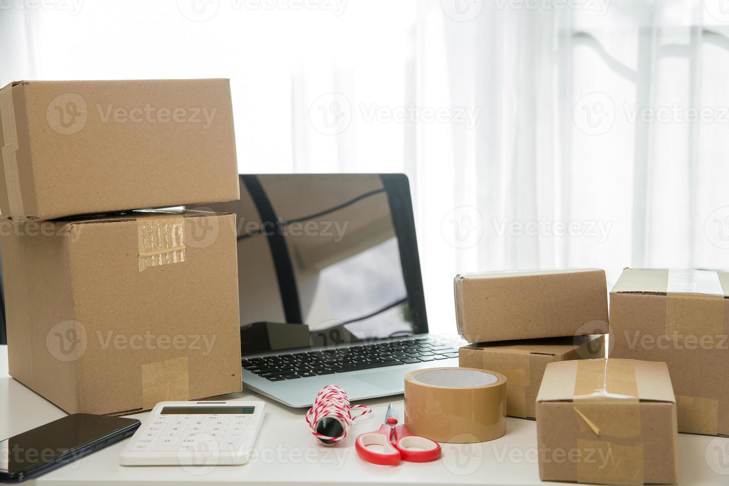 Equipments for SME online business, delivery business laptop, barcode, boxes, checking product on stocks or cardboard parcels. Small business working at home office. delivery service product at home. photo