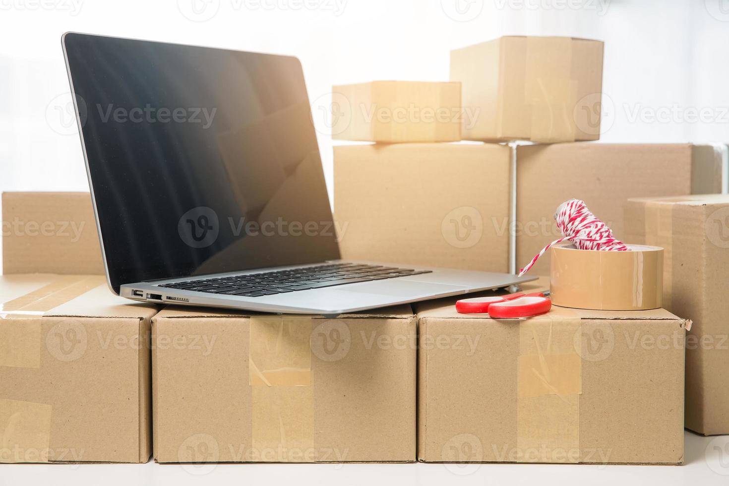 Equipments for SME online business, delivery business laptop, barcode, boxes, checking product on stocks or cardboard parcels. Small business working at home office. delivery service product at home. photo