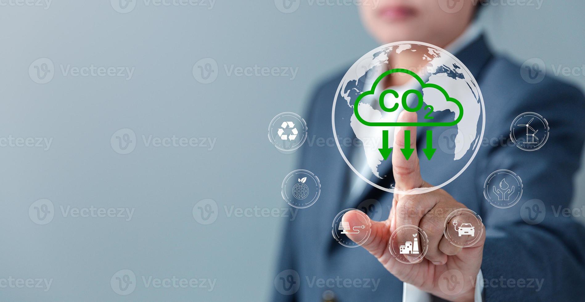 Sustainable development and innovation green business concept. Businesswoman working virtual globe modern computer to reduce CO2 emissions carbon footprint climate change to limit global warming. photo
