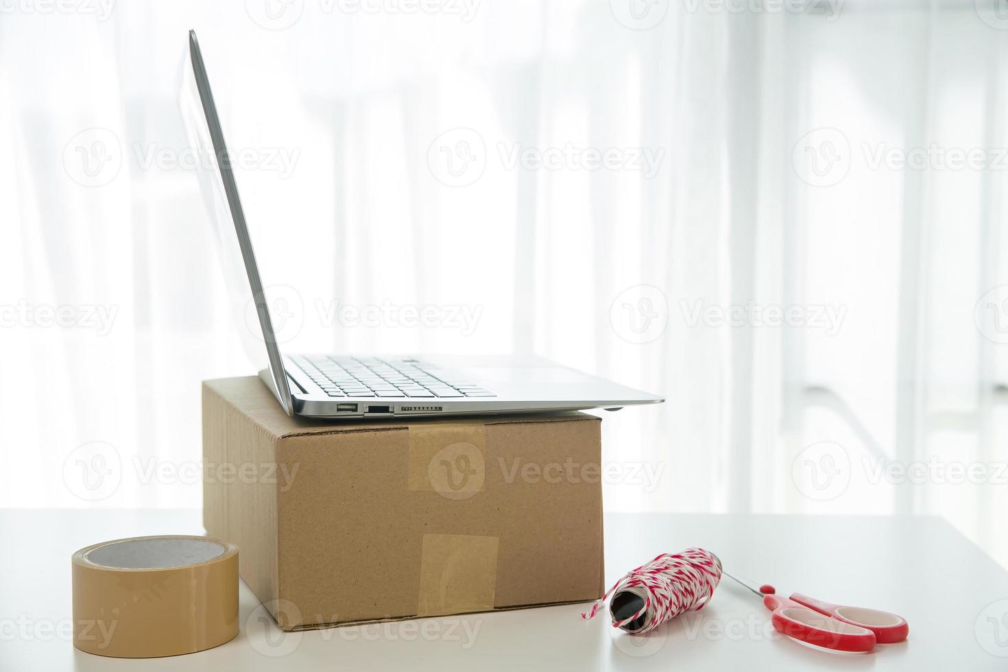 Equipments for SME online business, delivery business laptop, barcode, boxes, checking product on stocks or cardboard parcels. Small business working at home office. delivery service product at home. photo