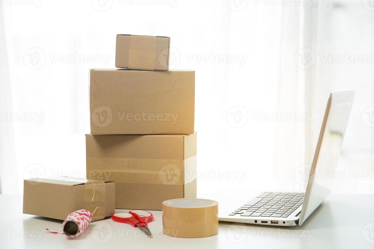 Equipments for SME online business, delivery business laptop, barcode, boxes, checking product on stocks or cardboard parcels. Small business working at home office. delivery service product at home. photo