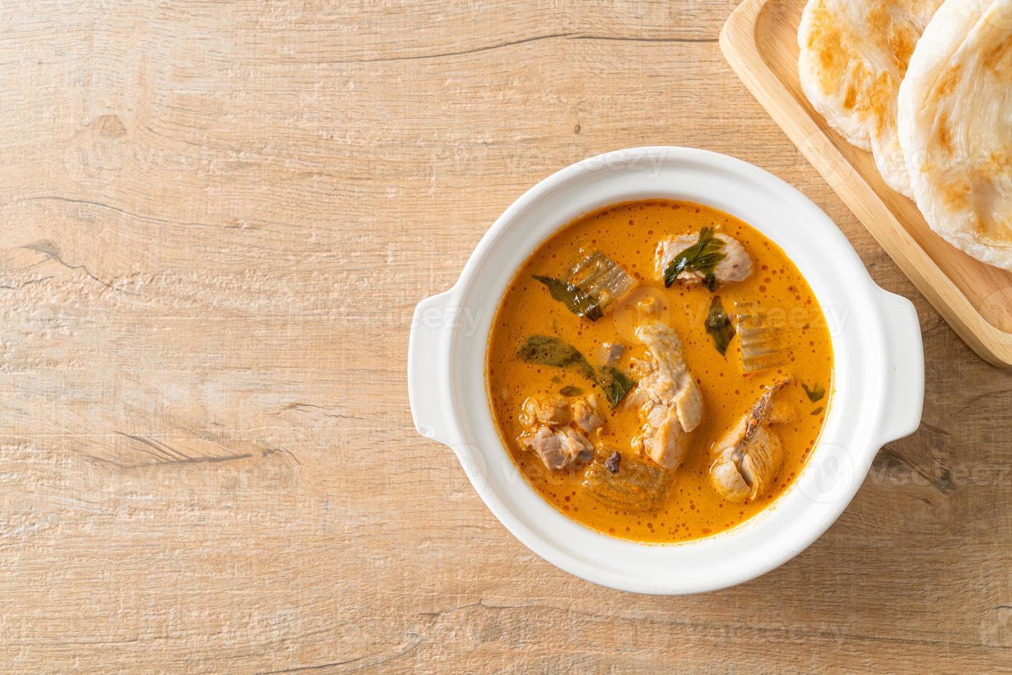 Chicken curry soup with roti photo