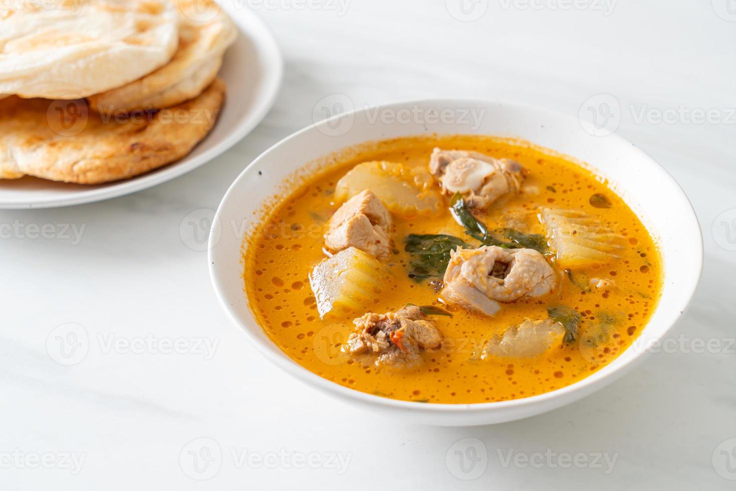 Chicken curry soup with roti photo
