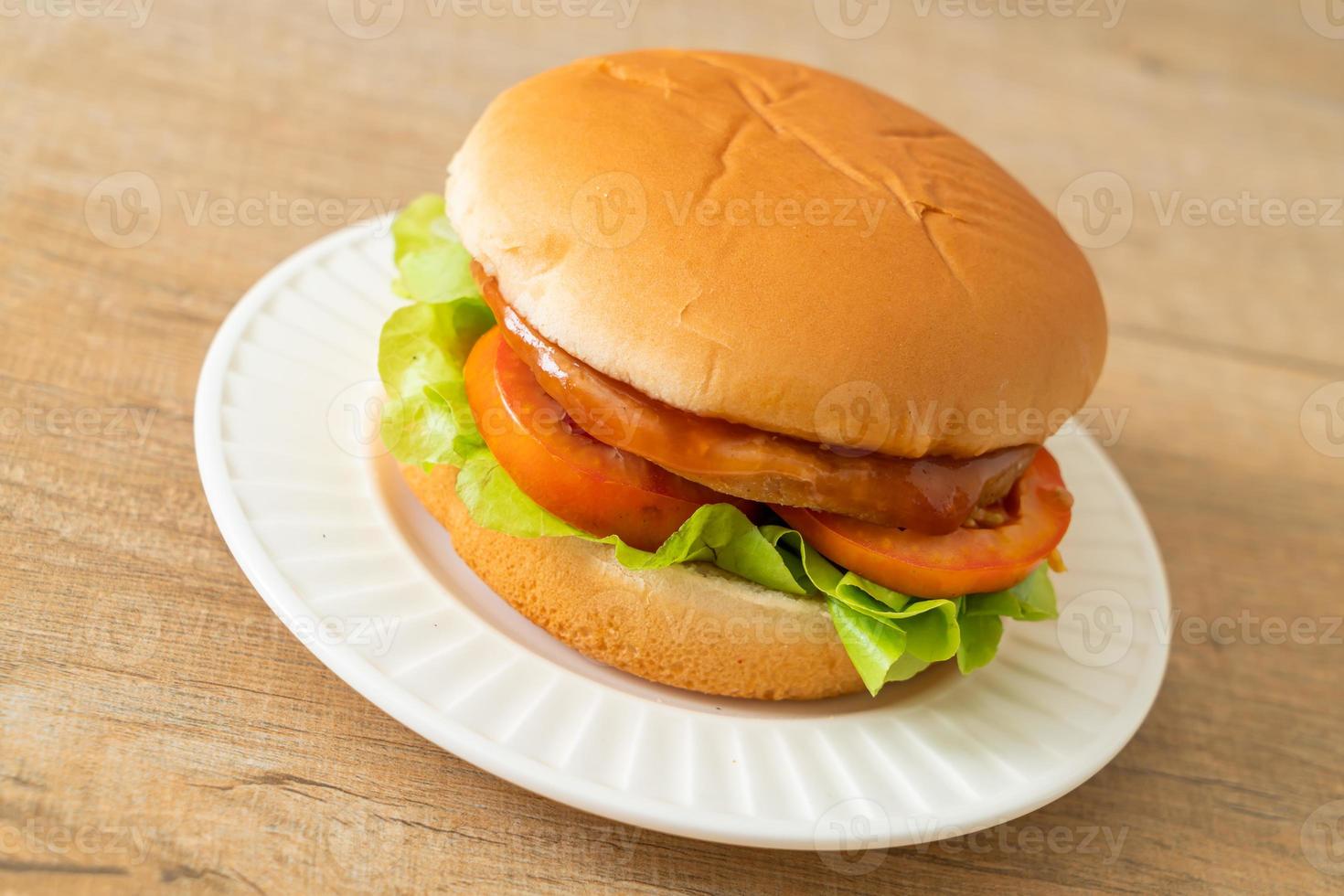 chicken burger with sauce on plate photo
