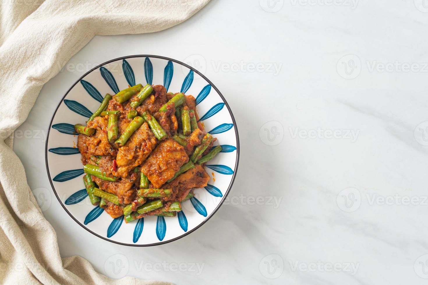 Stir fried pork with red curry paste photo
