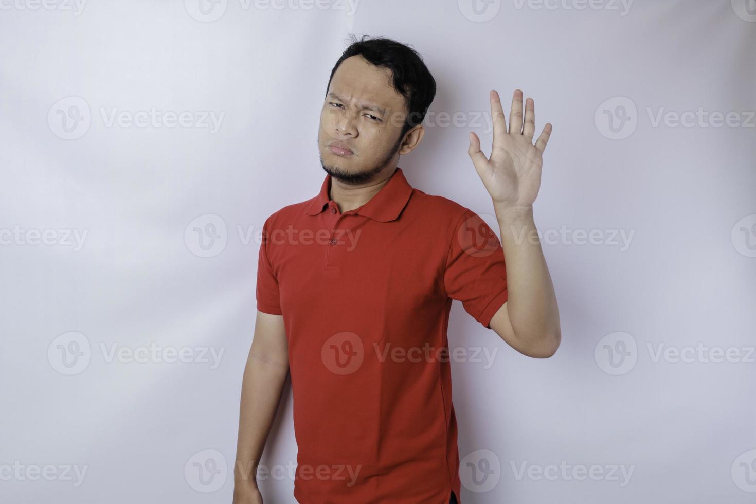 Attractive Asian man with hand gesture pose rejection or prohibition with copy space photo