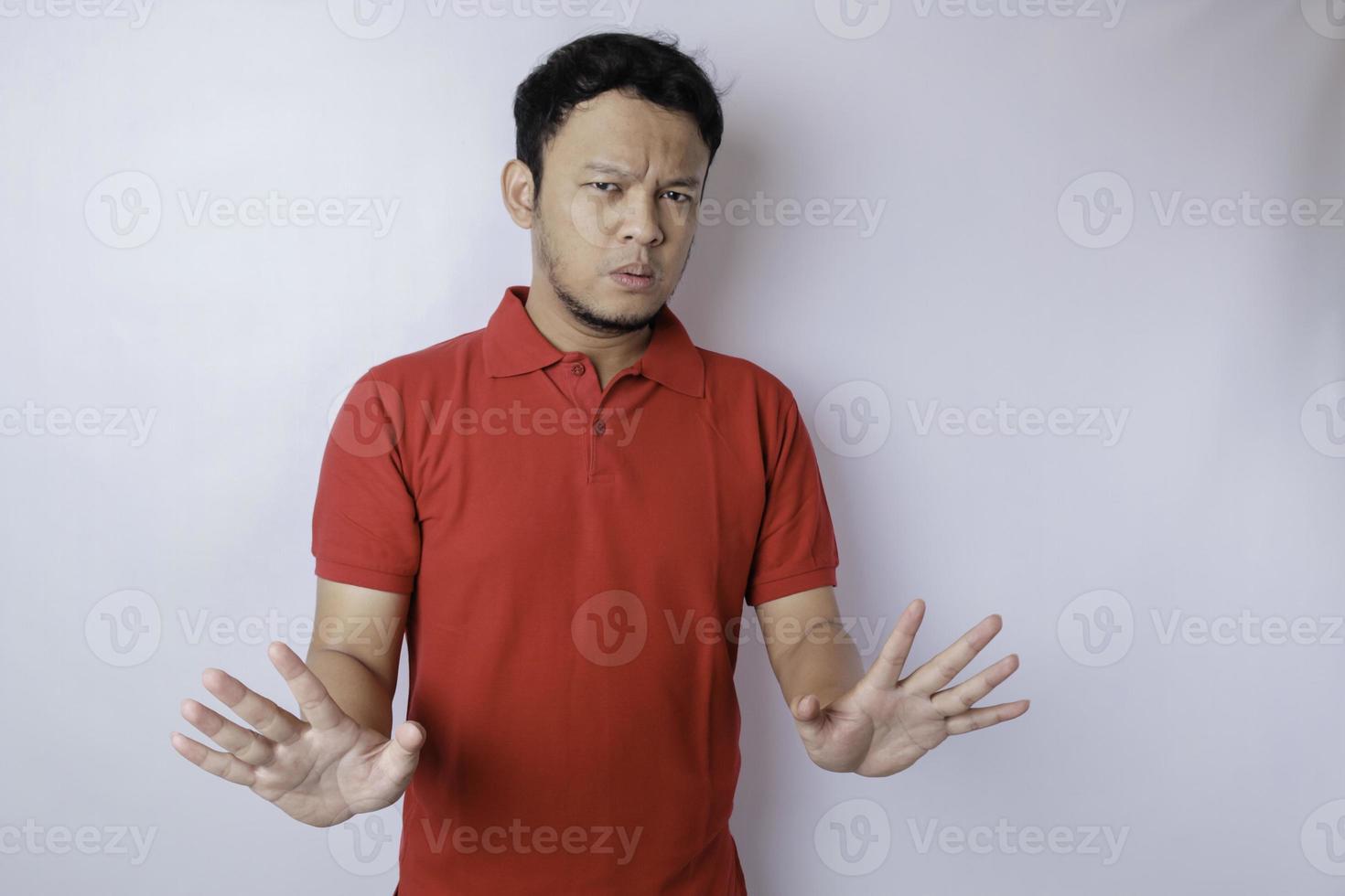 Attractive Asian man with hand gesture pose rejection or prohibition with copy space photo