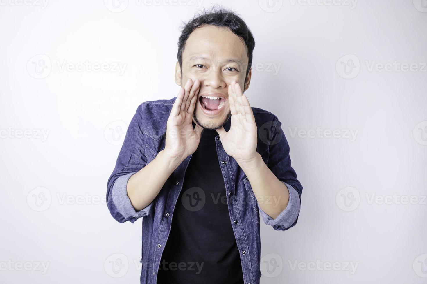 Young beautiful man wearing a blue navy shirt shouting and screaming loud with a hand on his mouth. communication concept. photo