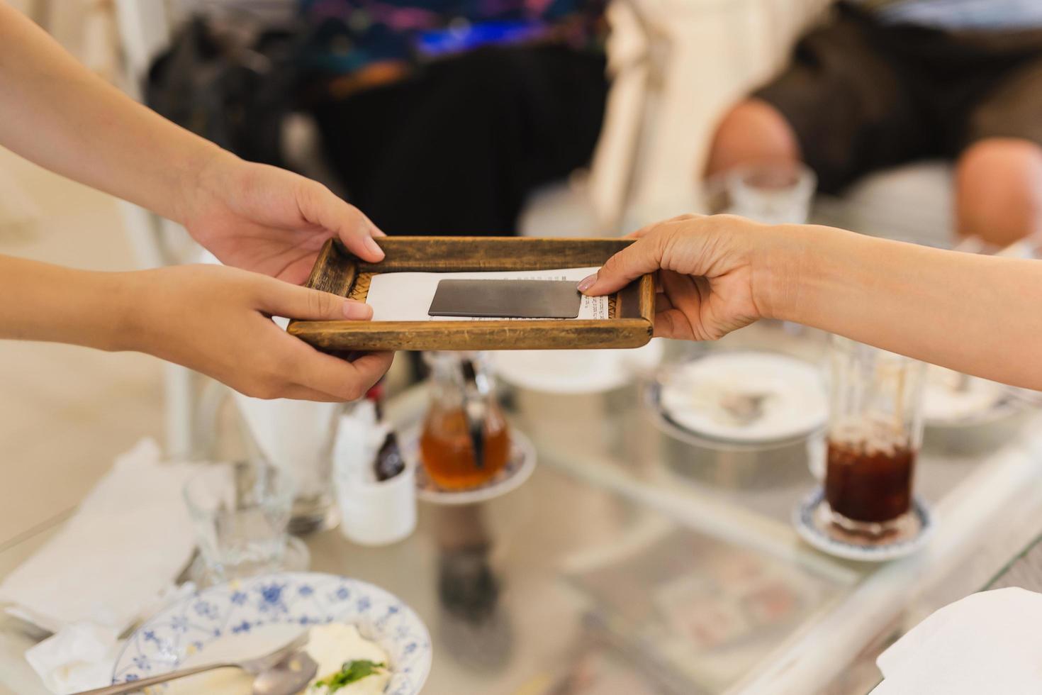 Customer paying bill in cafe with credit card. photo
