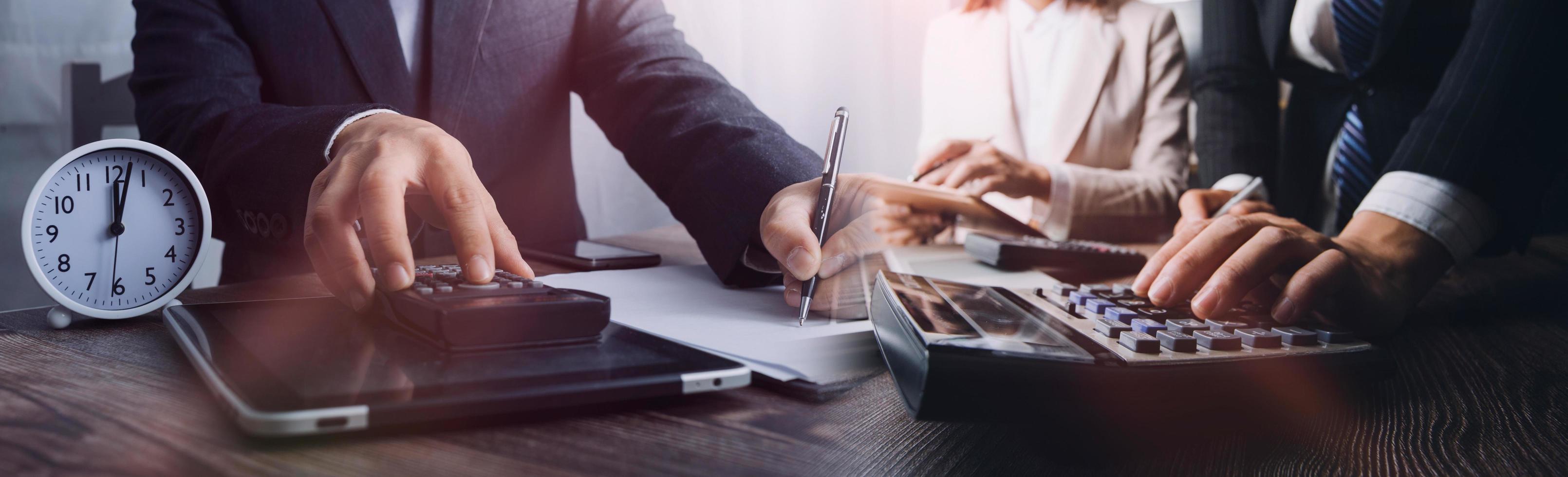 Business accounting concept, Business man using calculator with computer laptop, budget and loan paper in office. photo