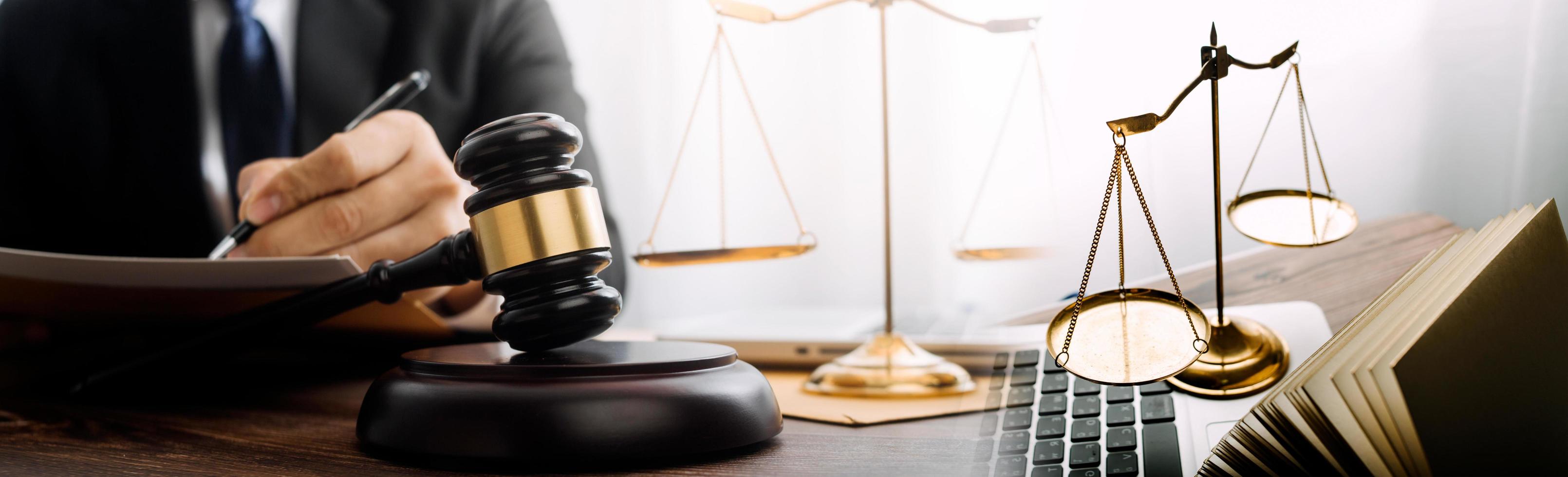 Business and lawyers discussing contract papers with brass scale on desk in office. Law, legal services, advice, justice and law concept picture with film grain effect photo