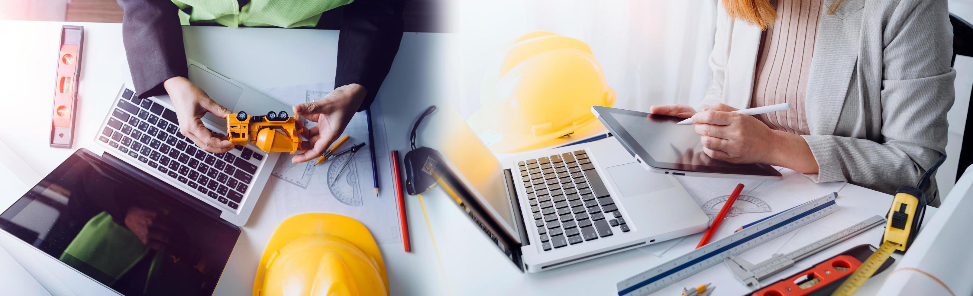 Two colleagues discussing data working and tablet, laptop with on on architectural project at construction site at desk in office photo
