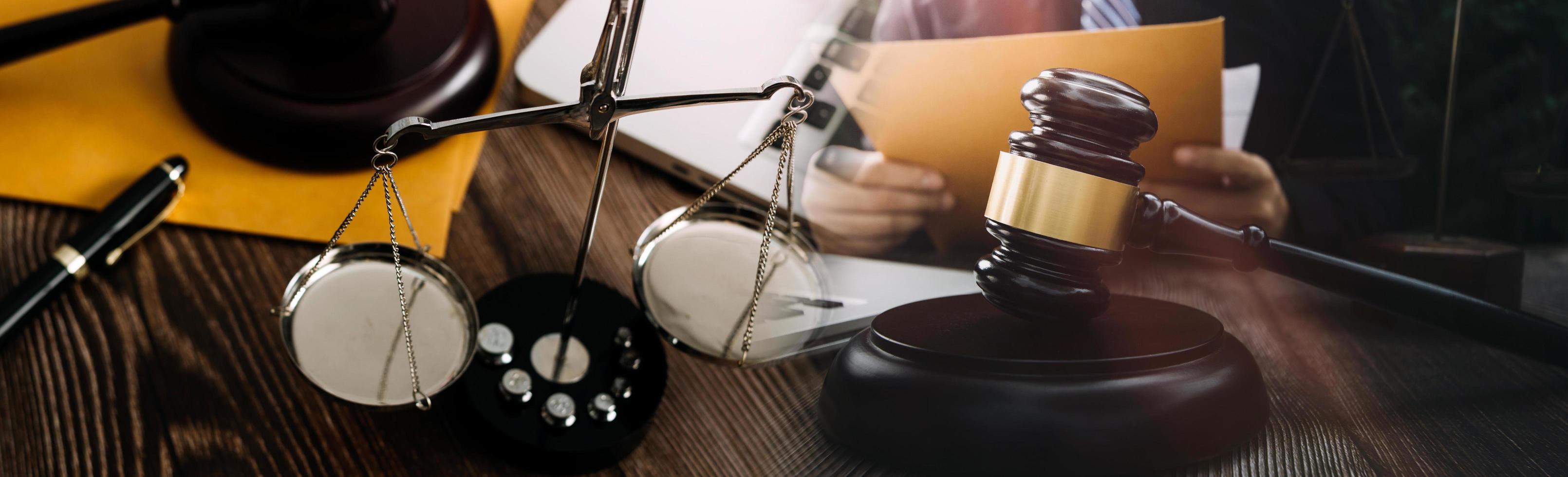 Business and lawyers discussing contract papers with brass scale on desk in office. Law, legal services, advice, justice and law concept picture with film grain effect photo