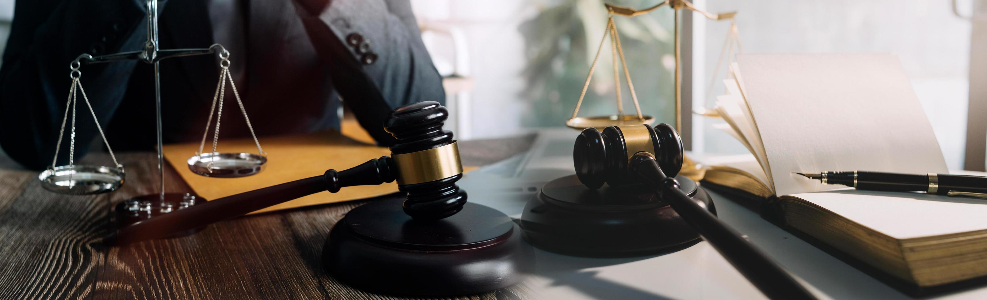 Business and lawyers discussing contract papers with brass scale on desk in office. Law, legal services, advice, justice and law concept picture with film grain effect photo