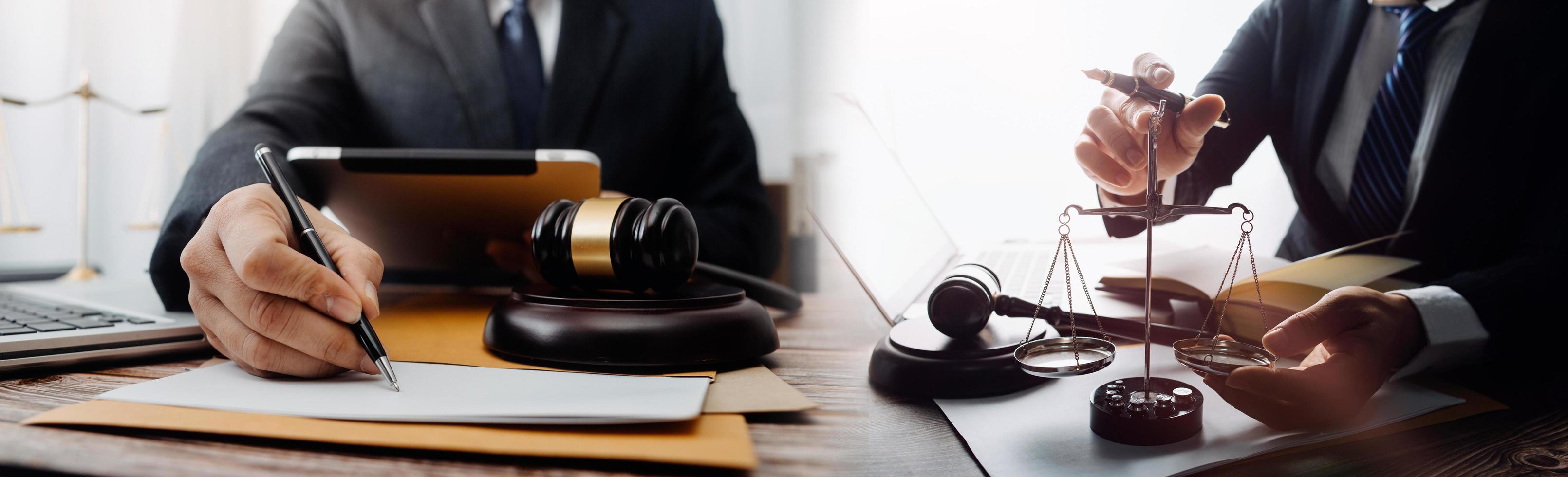 Business and lawyers discussing contract papers with brass scale on desk in office. Law, legal services, advice, justice and law concept picture with film grain effect photo