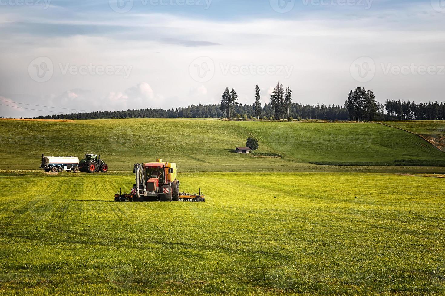 Application of manure on arable farmland with the heavy tractor who works at the field in Germany photo
