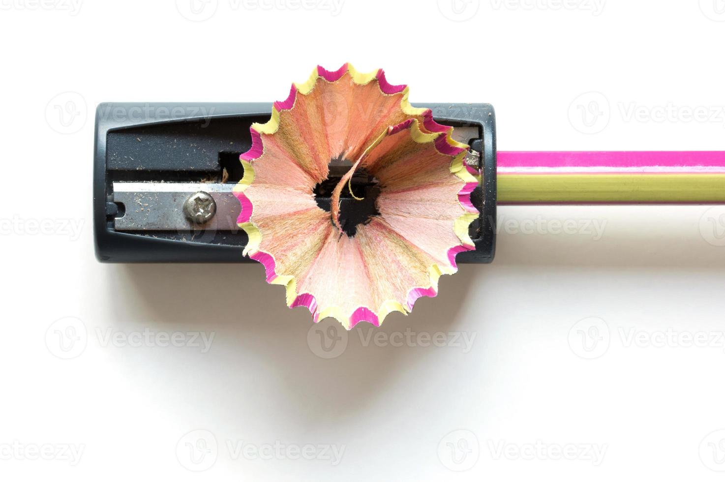 pencil with sharpening shavings on white background photo