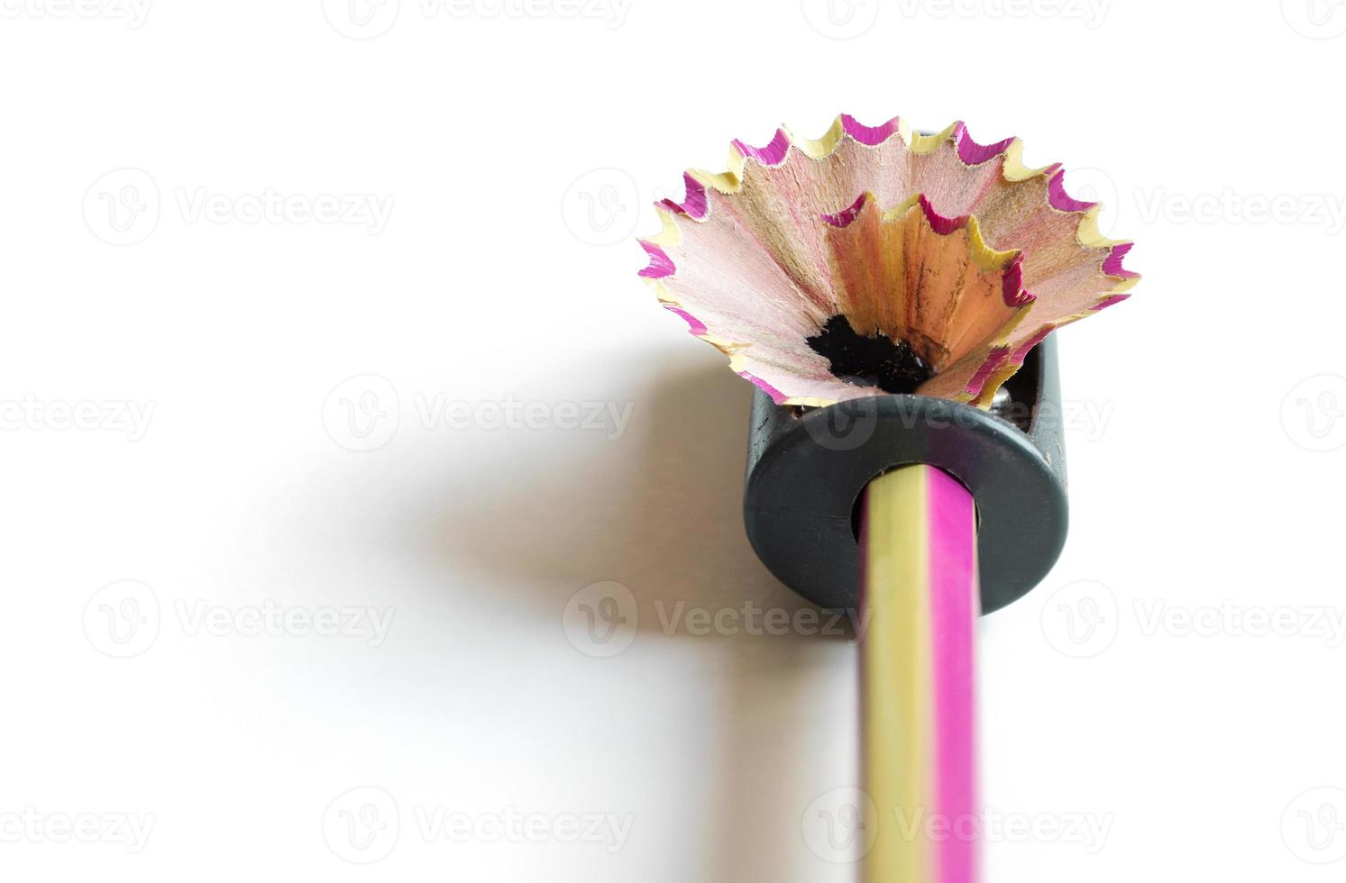 pencil with sharpening shavings on white background photo
