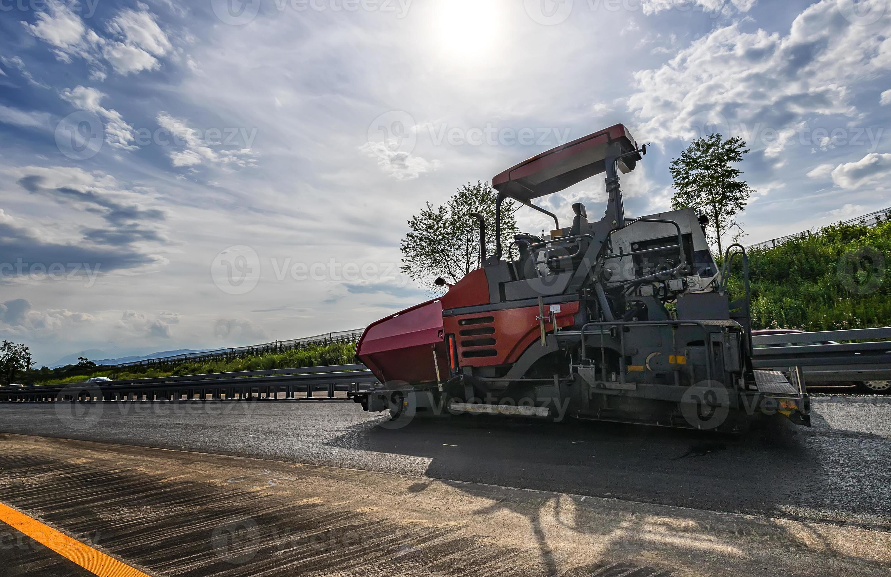 Asphalt machine makes a new road. A paver finisher, asphalt finisher or