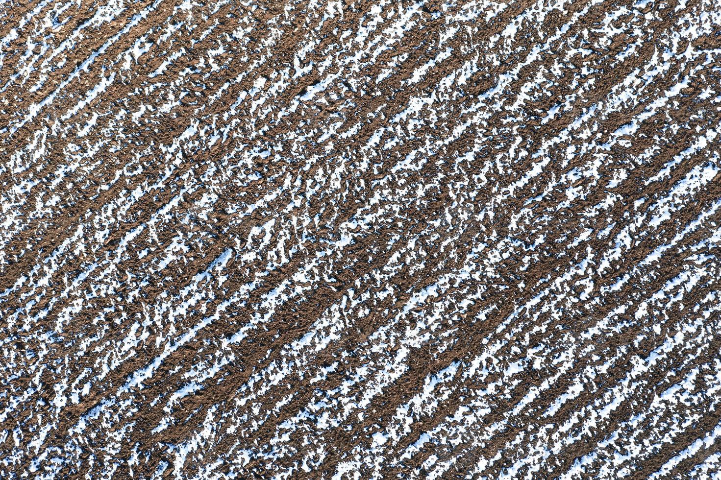 The plowed field in winter. Fields covered with snow. View from the top. photo