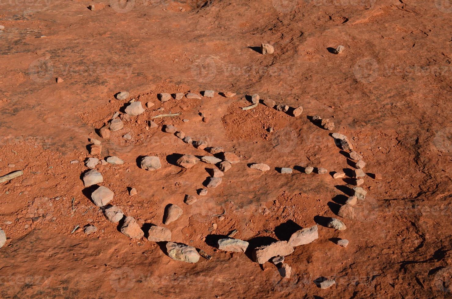 Peace Sign Created from Rocks on Red Dirt photo