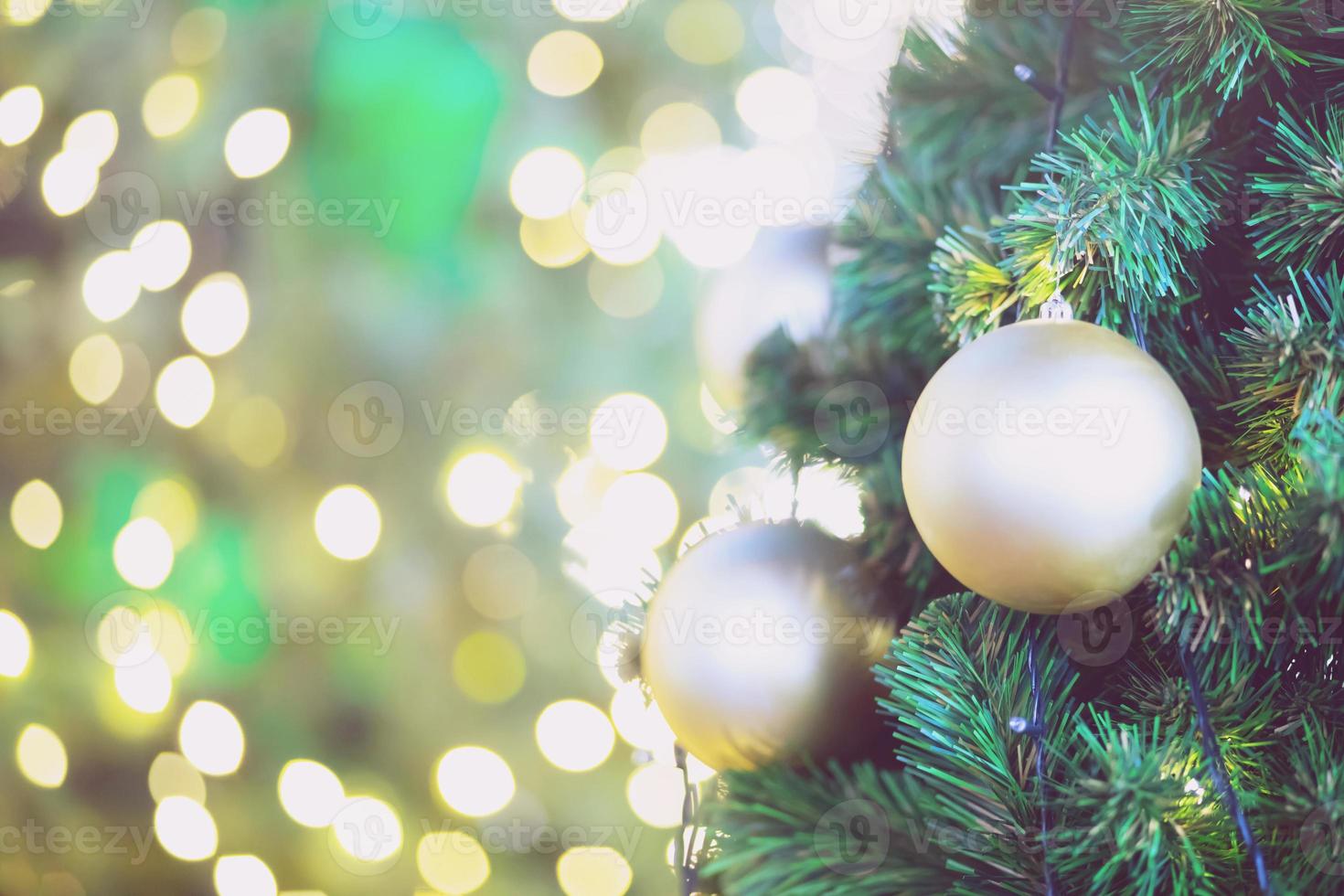 Closeup of bauble colorful variety hanging from a decorated christmas tree on blurred of lights with decorated tree, sparkling and bokeh background. copy space for your text. Christmas Tree Decoration photo