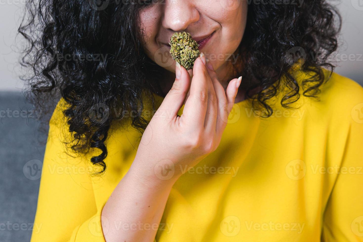 Adult woman holding in the hand medical marijuana buds, close up photo