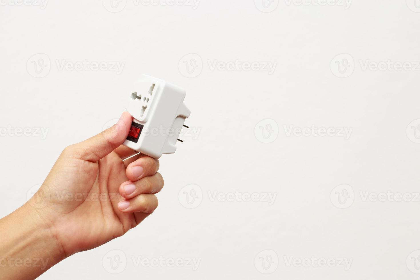 An extension socket is a device that consists of several components, such as a power cord, an electrical socket, an outlet, a power strip, and an electrical switch. photo