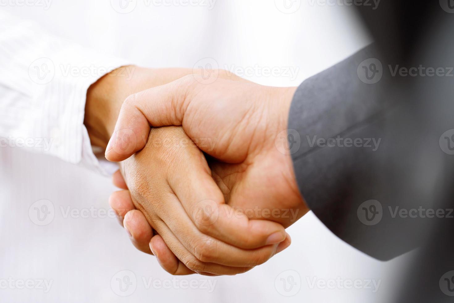 Closeup of a business hand shake between two colleagues Plaid shirt photo