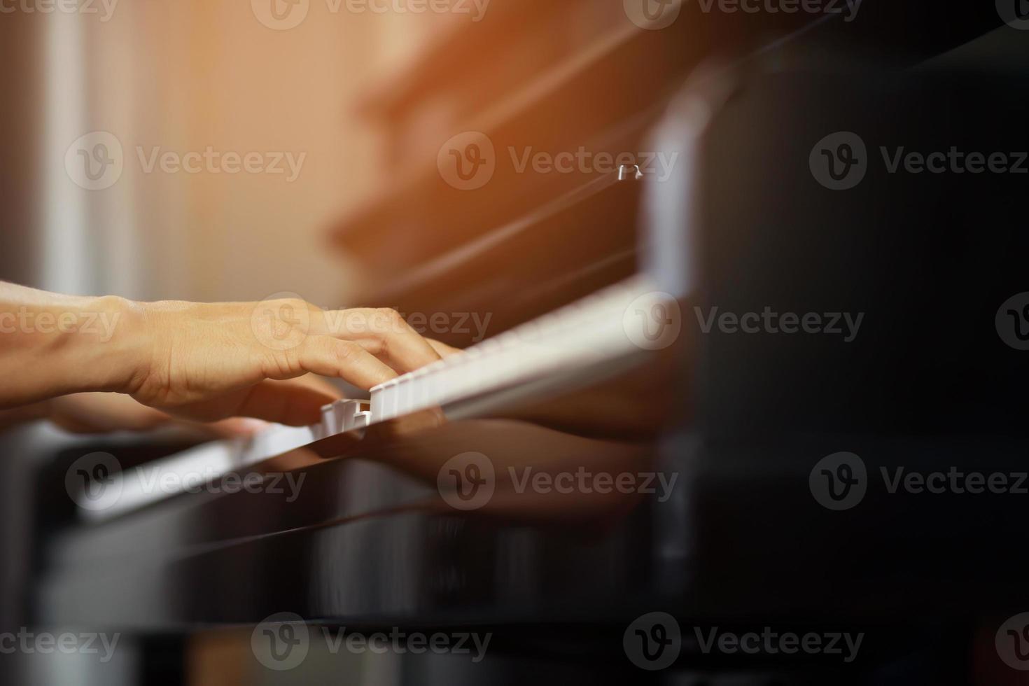 close up of hand people man musician playing piano keyboard with selective focus keys. can be used as a background. photo