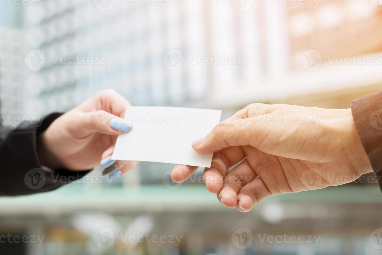 business man in hand hold show business cards blank white card mock up filing give to connect business contacts. Business branding concept. photo