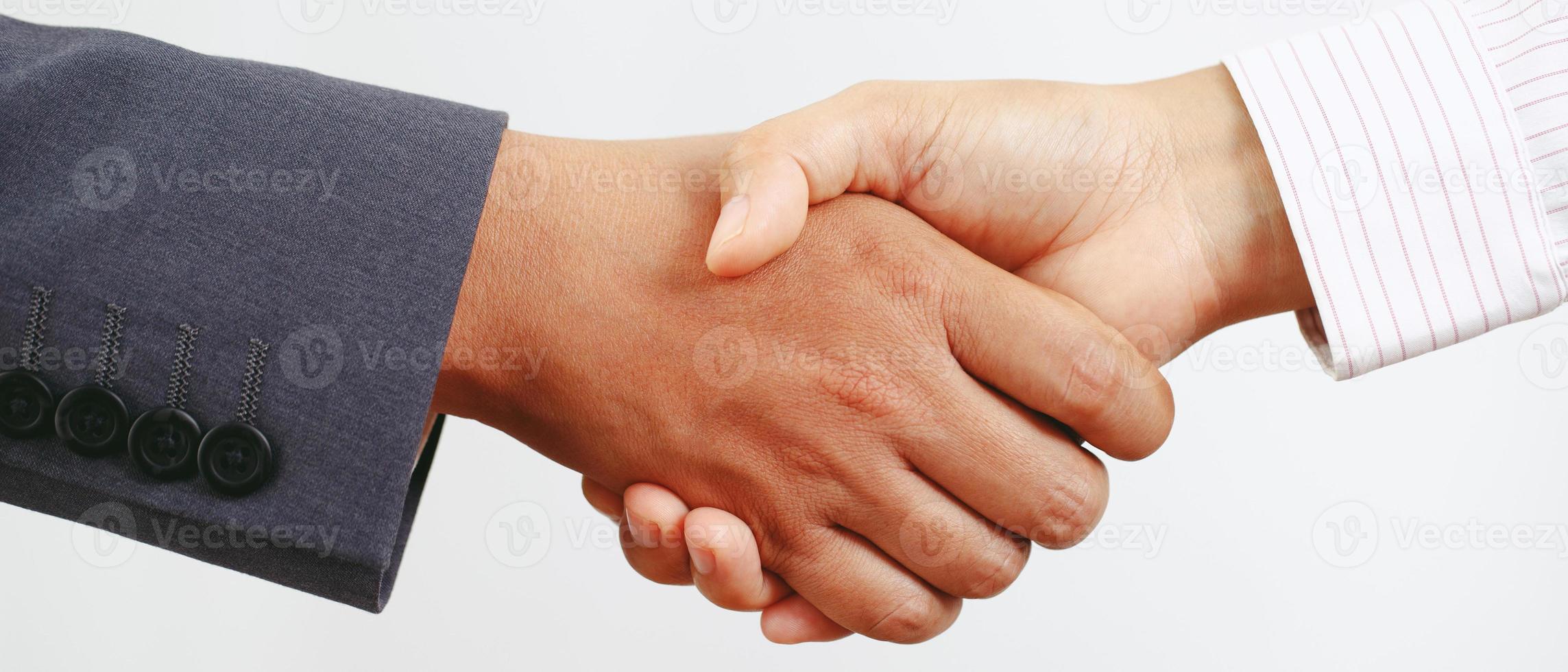 Closeup of a business hand shake between two colleagues Plaid shirt photo