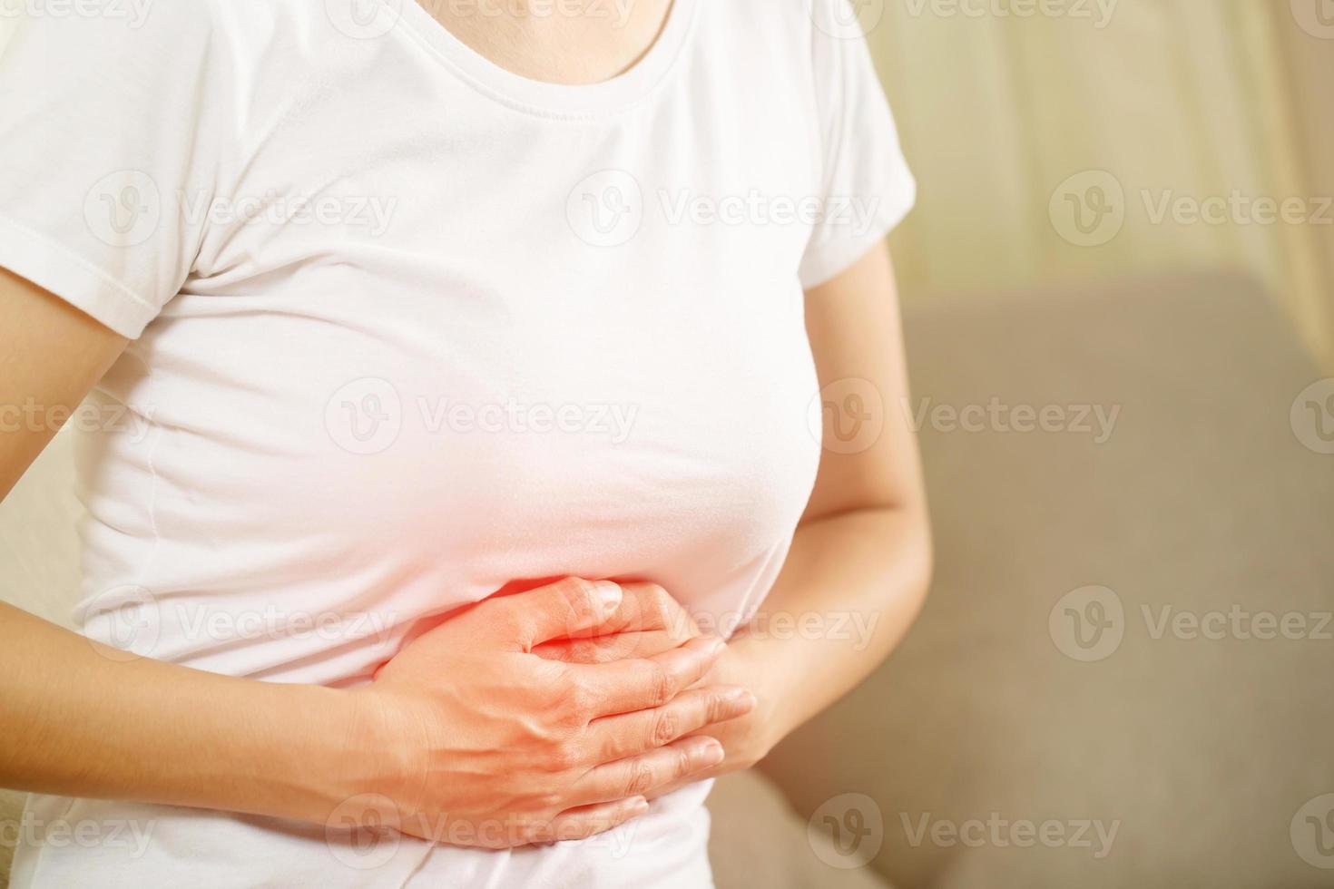 Woman having a stomachache, or menstruation pain. suffering from abdominal. Menstrual cramps. Healthcare and medical, gynecology concept. photo