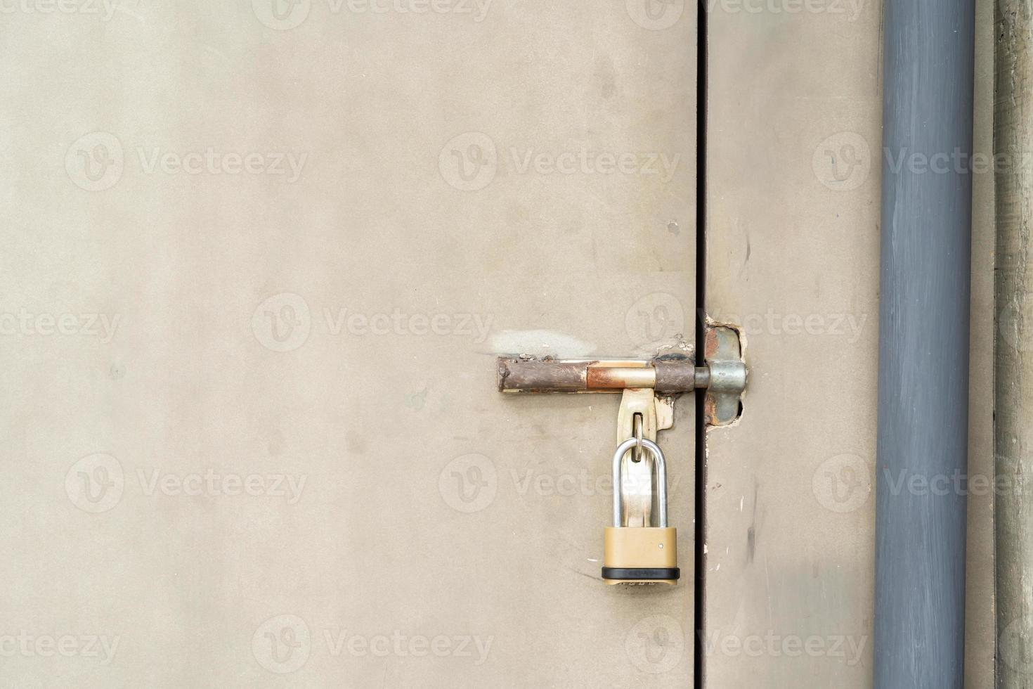 closed door with padlock. metal door texture background with space photo