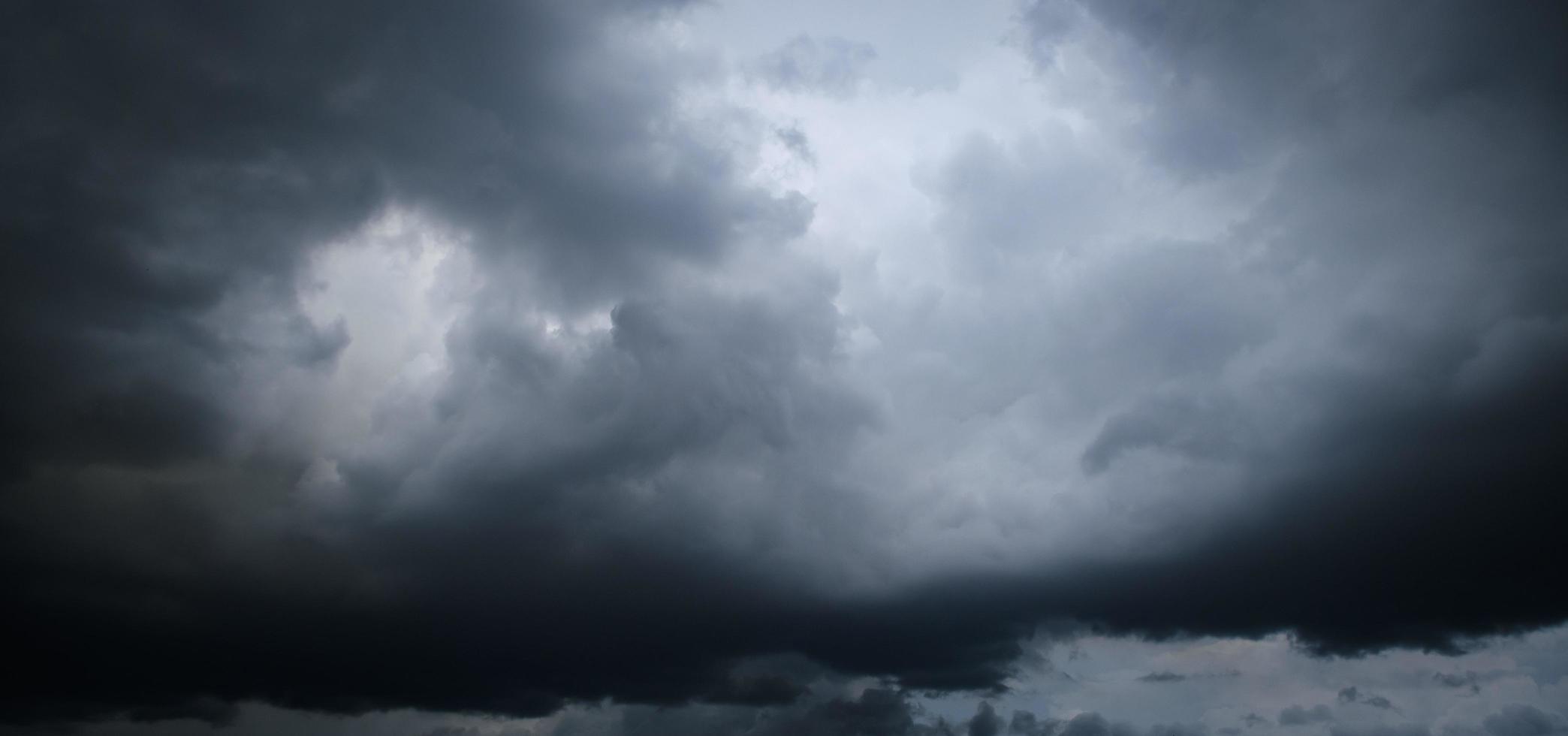 Storm clouds floating in a rainy day with natural light. Cloudscape scenery, overcast weather above blue sky. White and grey clouds scenic nature environment background photo