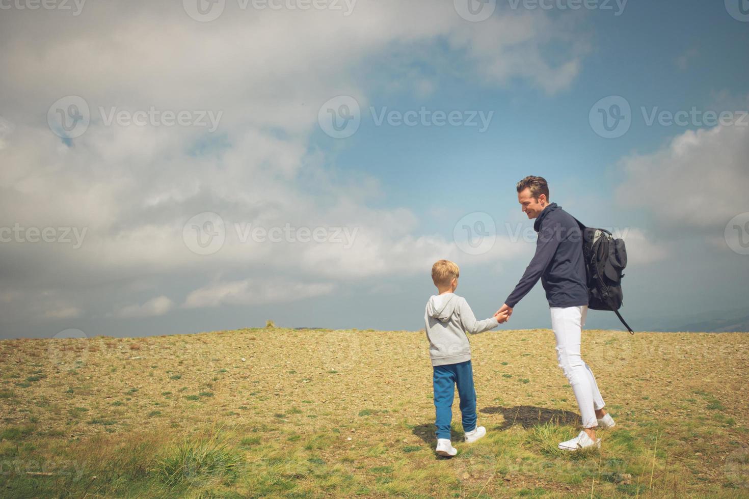 Father and son talking while spending day nature. photo