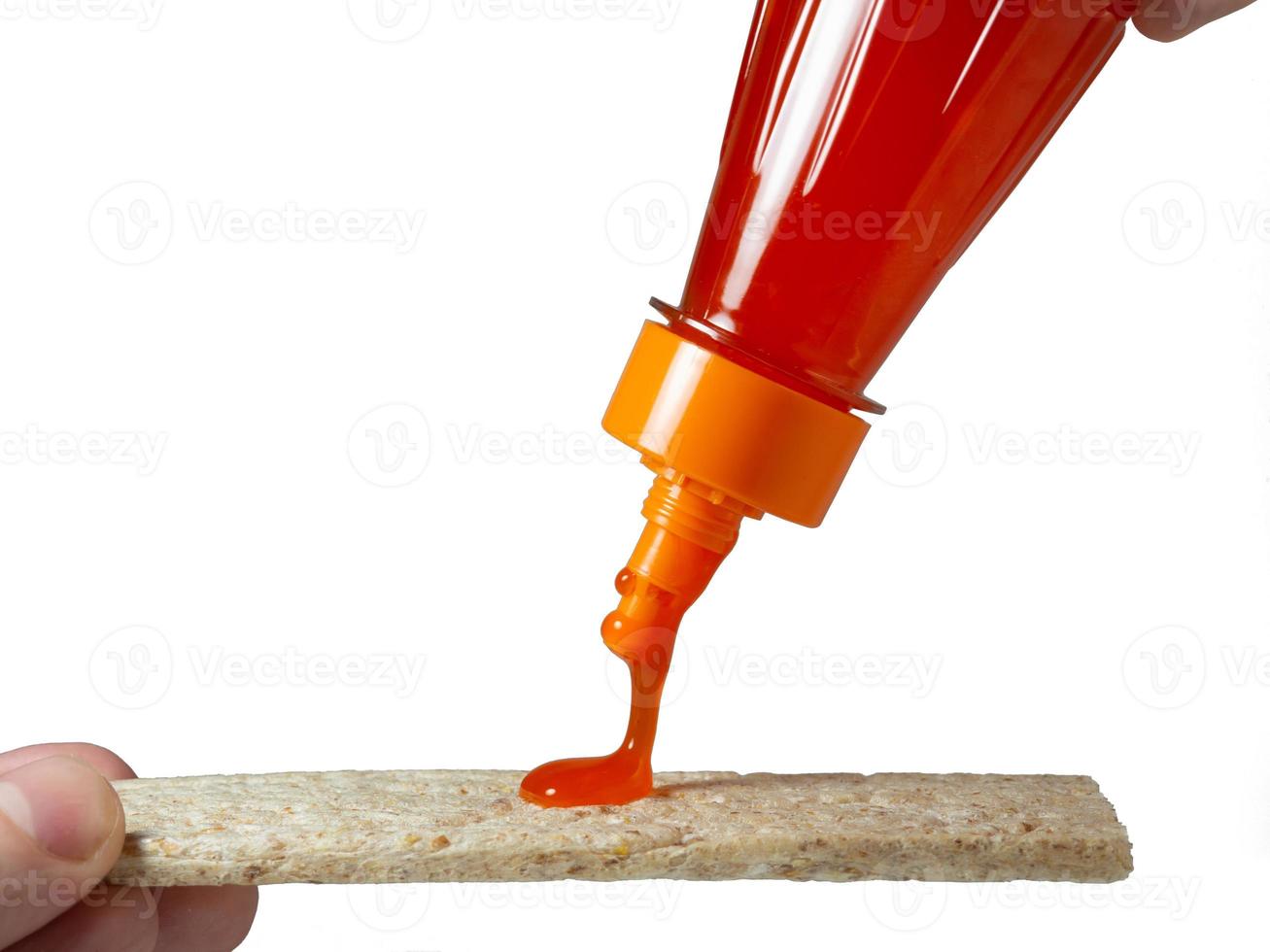 A loaf of bread is poured with a spicy sauce. Seasoning for food photo