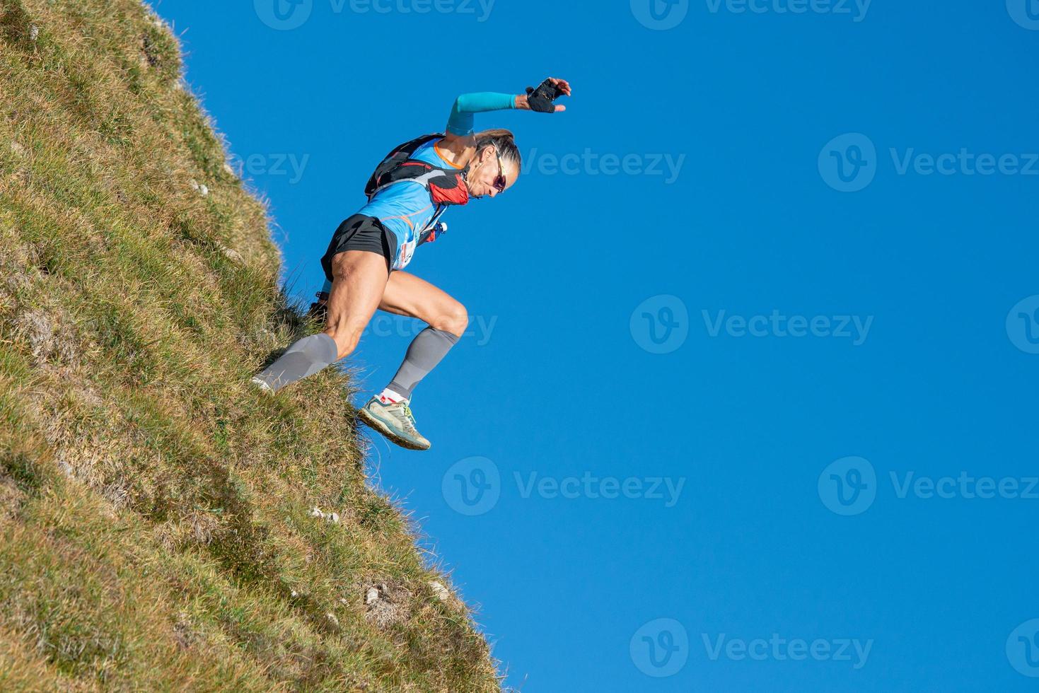 Woman running in the mountains photo