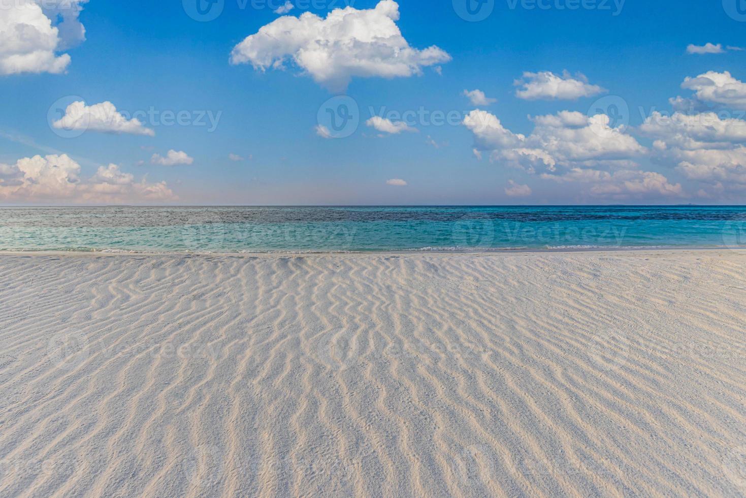 Perfect beach landscape. Tropical island paradise, shore coast, seaside with cloudy blue sky and soft white sand with ripples. Calm relaxing sea horizon. Summer vacation travel landscape, nature view photo