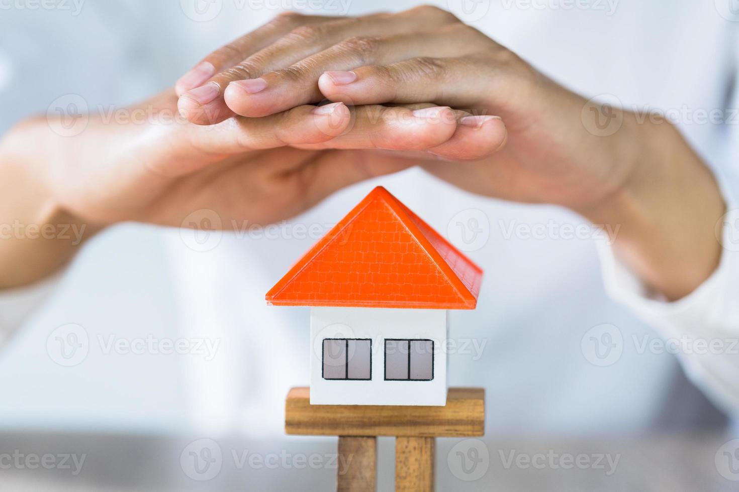 Woman Hand protection house, Investment risk and uncertainty in the real estate housing market, insurance. photo