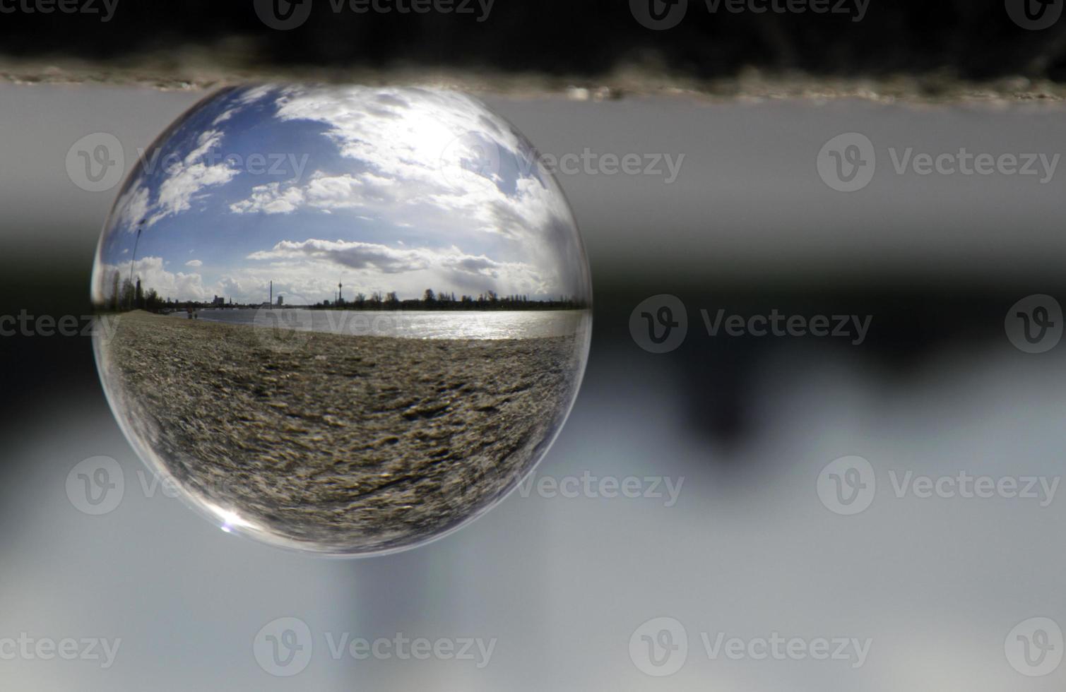 The skyline of Dusseldorf, Germany, seen through a glass orb photo